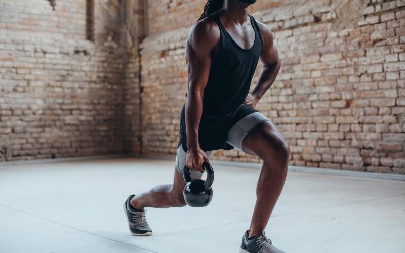 a man doing lunges with kettlebell